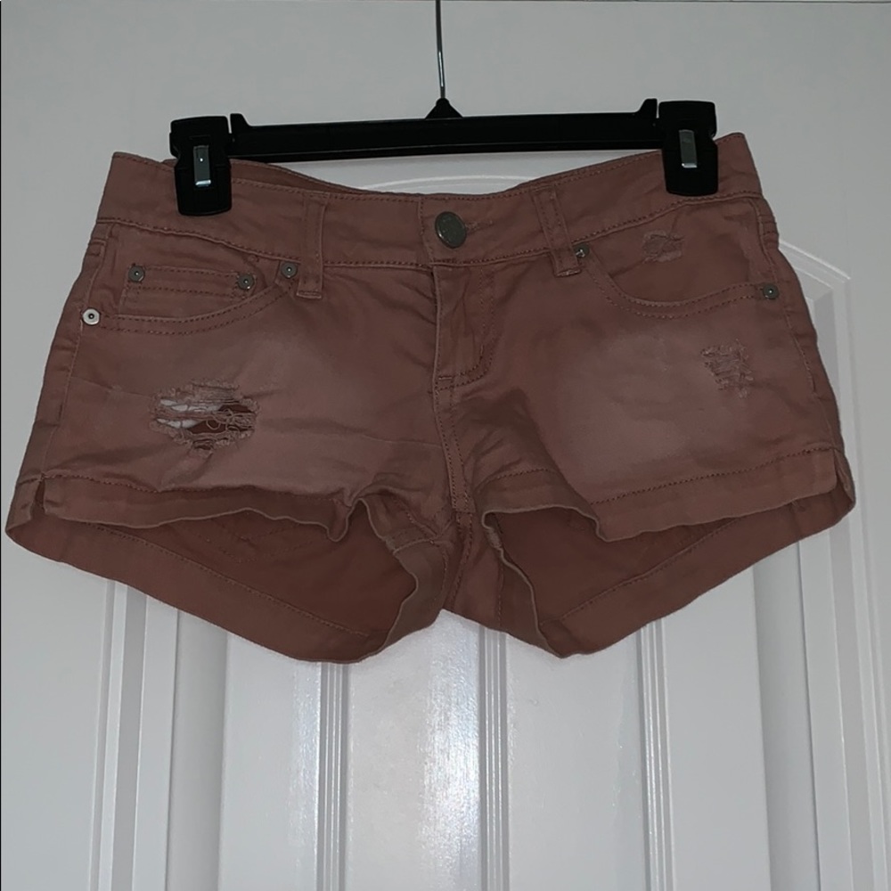 mildly distressed light pink shorts